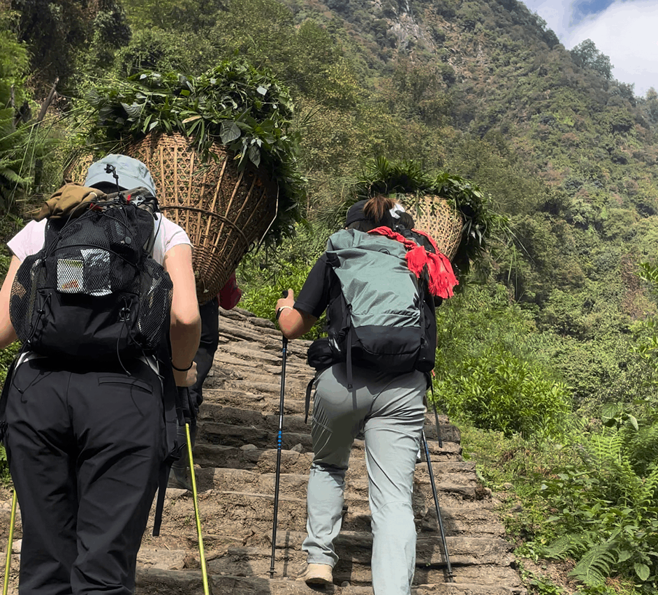Trekkers and Local Porters Hiking Uphill in the Annapurna Region